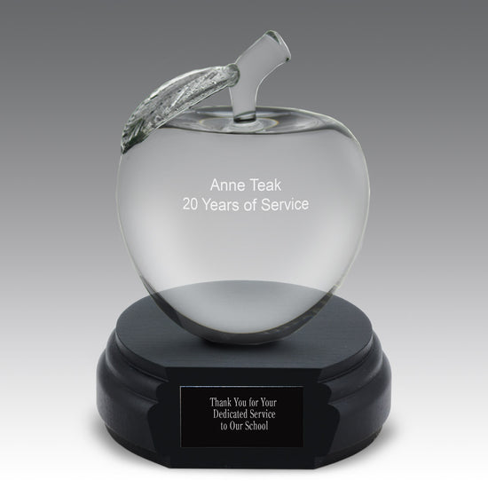optic crystal apple with leaf and stem on a black base