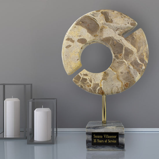 Marble Circle of Distinction award with gold rod and black marble base.