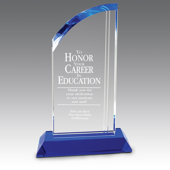Optic crystal arch award with blue crystal base. 5.25x2x8.75 inches. Etched pre-designed educational message with custom logo.