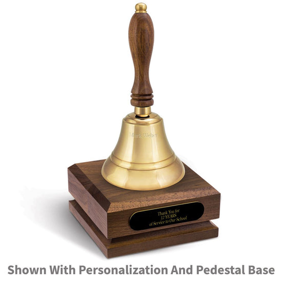 personalized brass bell sitting on top a walnut base with black brass plate