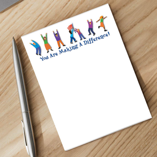 making a difference notepad and silver pen sitting on a desk