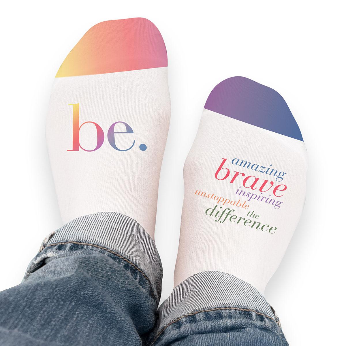 Pair of no-show socks with a colorful Be The Difference message on top.