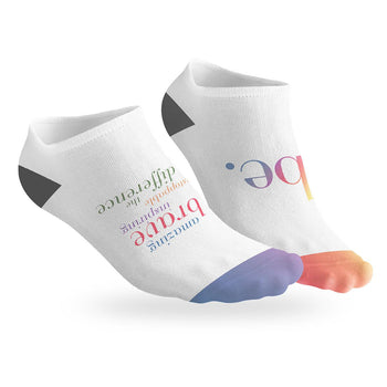 pair of no-show socks with a black heel and a colorful Be The Difference message on top.