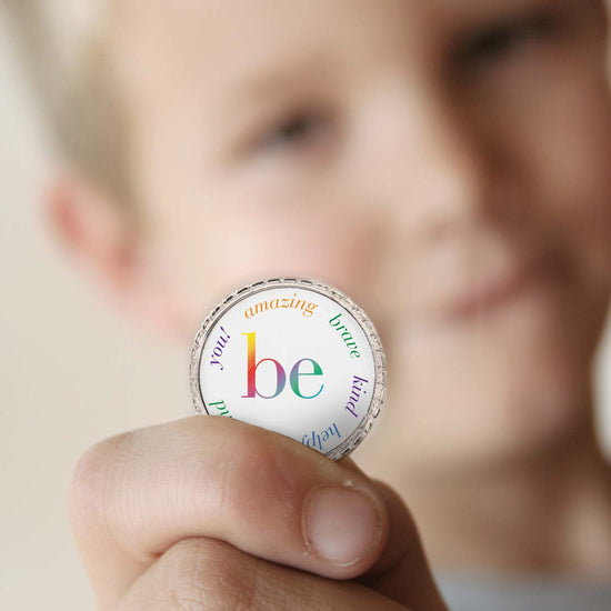 a boy holding a be collection coin