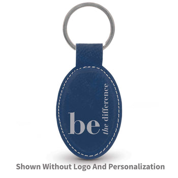 blue oval leather keychain with be the difference message