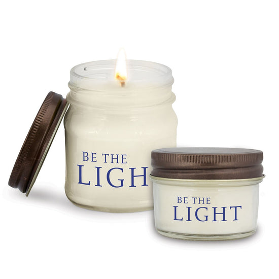 two white candle in glass jar with be the light message