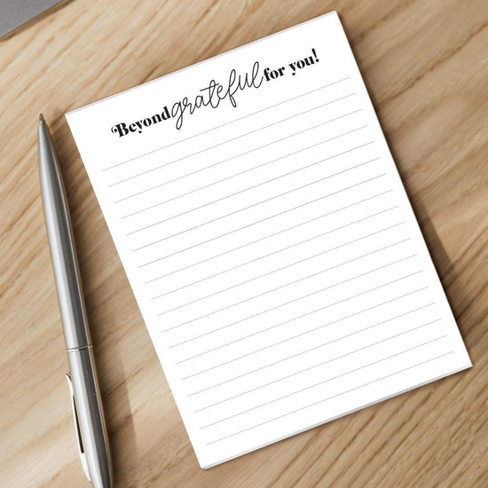 beyond grateful notepad and pen sitting on a desk