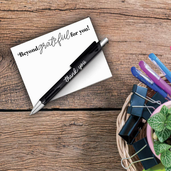 beyond grateful notepad and pen sitting on a desk