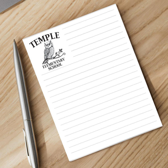 custom notepad sitting on a desk with a pen