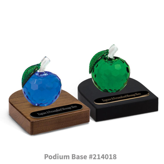 blue and green faceted crystal apples sitting on top of black and brown walnut podium bases with black brass plates