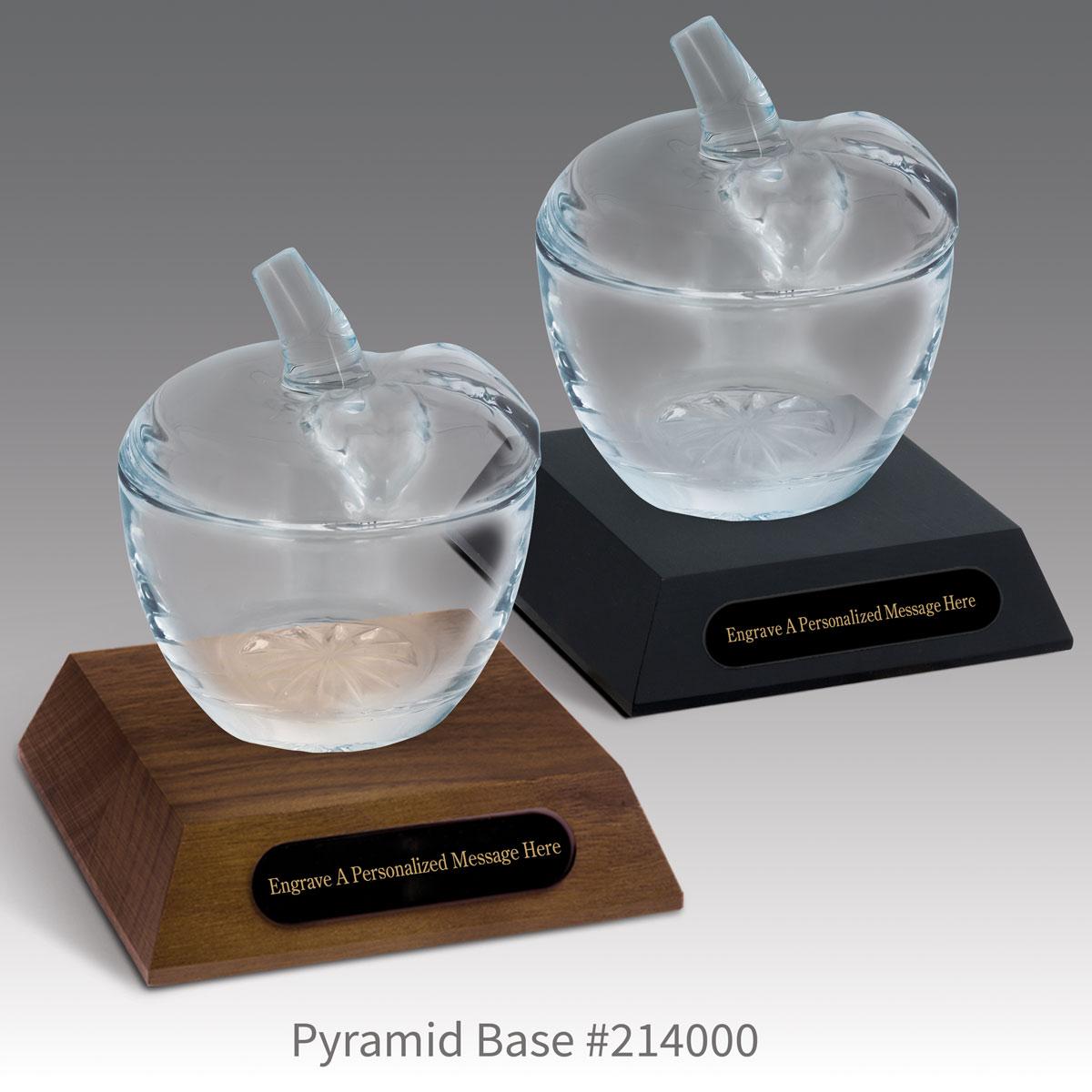 black and a brown walnut pyramid bases with black brass plates and glass apple dishes