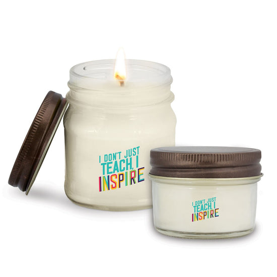 two mason jar candles with inspire message