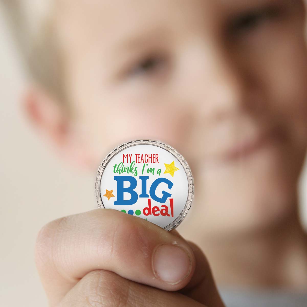 a boy holding a big deal kudo coin
