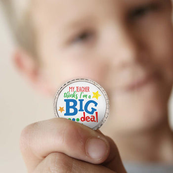 a boy holding a big deal kudo coin