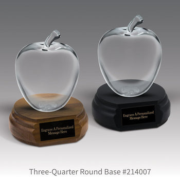 black and a brown walnut three-quarter round bases with black brass plates and large optic crystal apples