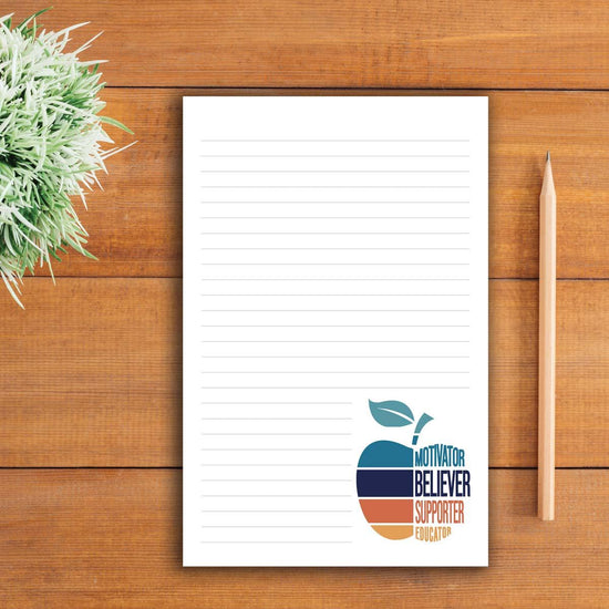 motivator believer supporter educator apple large notepad sitting on a table