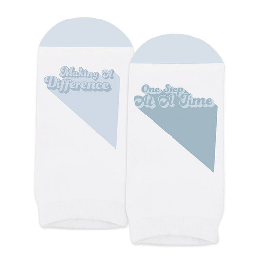 pair of no-show white socks with making a difference message