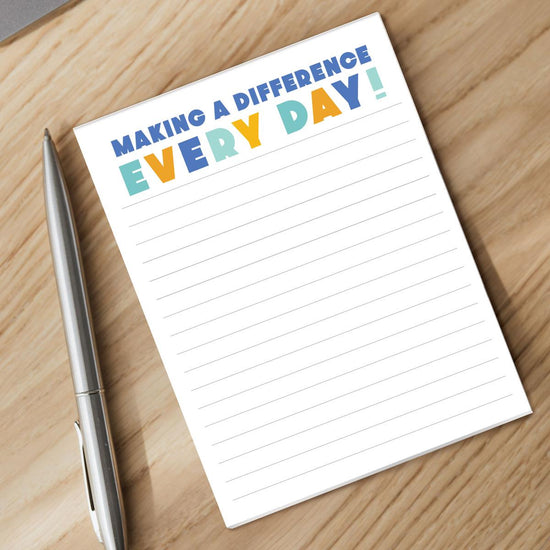 making a difference notepad and pen sitting on a desk