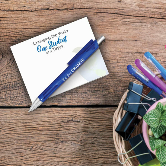 one student at a time notepad and pen sitting on a desk