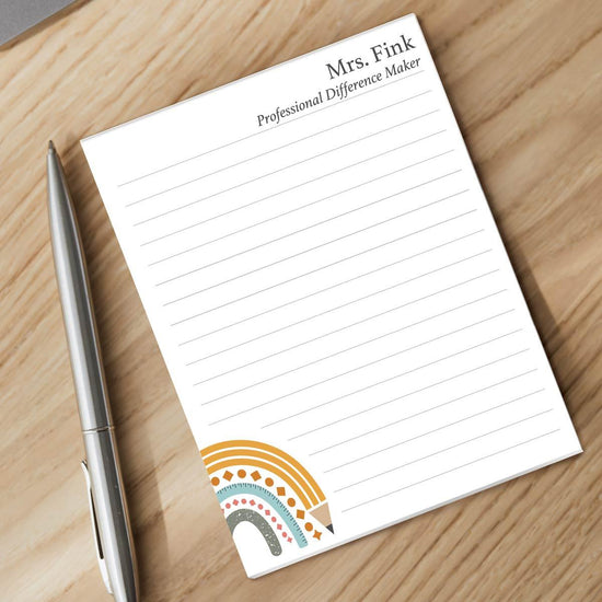 professional difference maker notepad and pen sitting on a desk