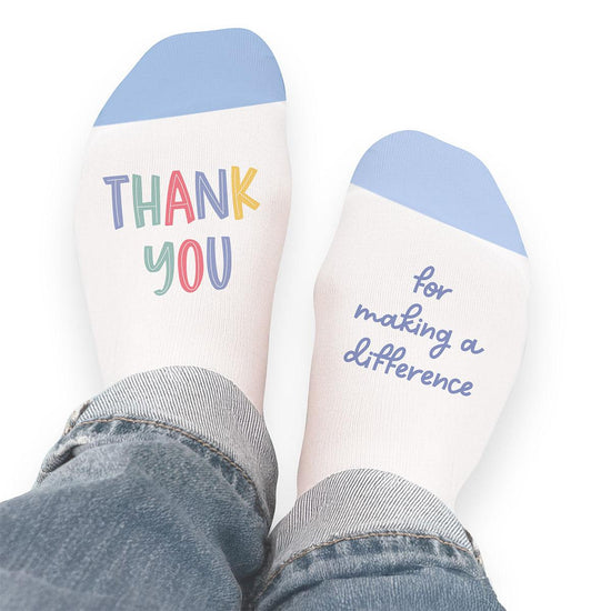 Pair of no-show socks with a black heel and a colorful Thank You For Making A Difference message on top.