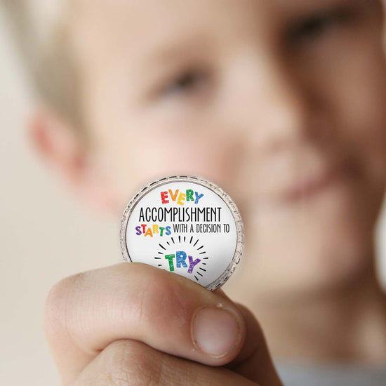 a boy holding a try coin