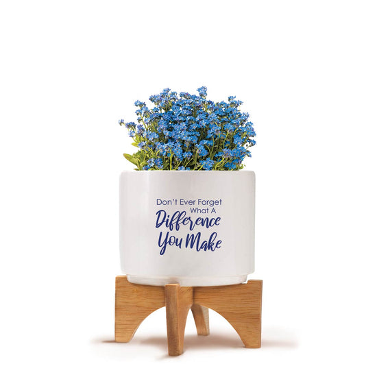 Two-piece bamboo stand with modern white ceramic planter featuring the inspirational message “Don’t Ever Forget What A Difference You Make.” Grows forget-me-nots.