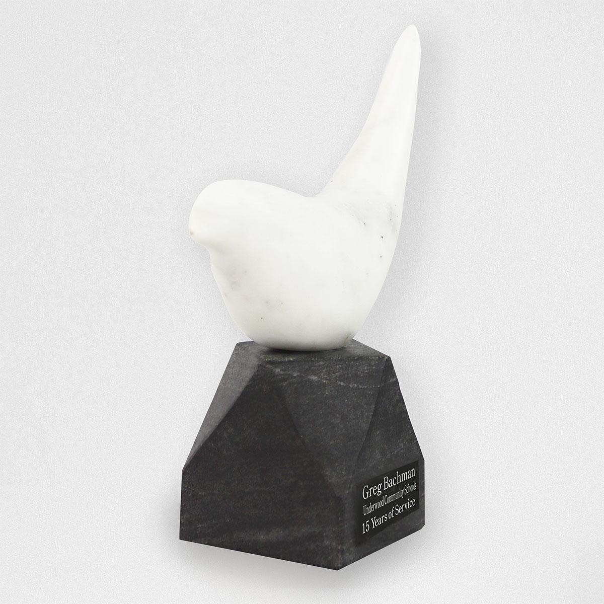 white marble bird on black marble base with personalized plate