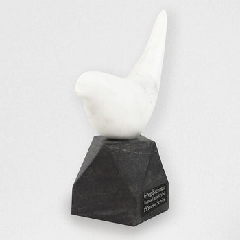 white marble bird on black marble base with personalized plate