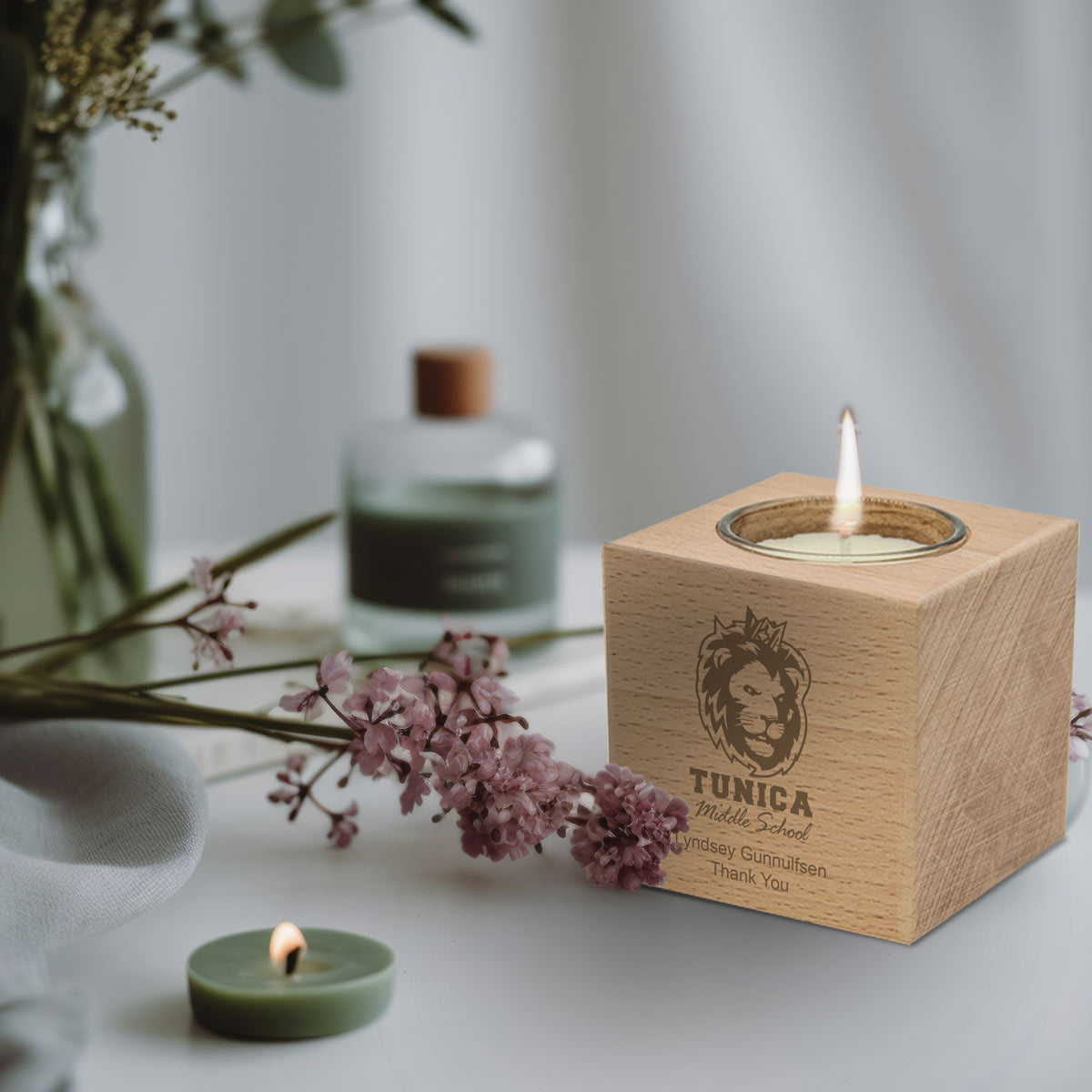 beechwood candle holder with custom logo sitting on desk