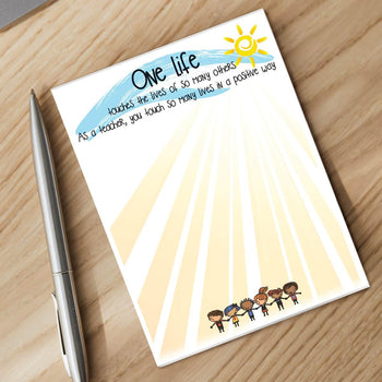 one life notepad and silver pen sitting on a desk