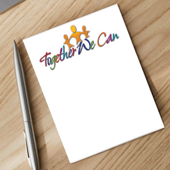 together we can notepad and silver pen sitting on a desk