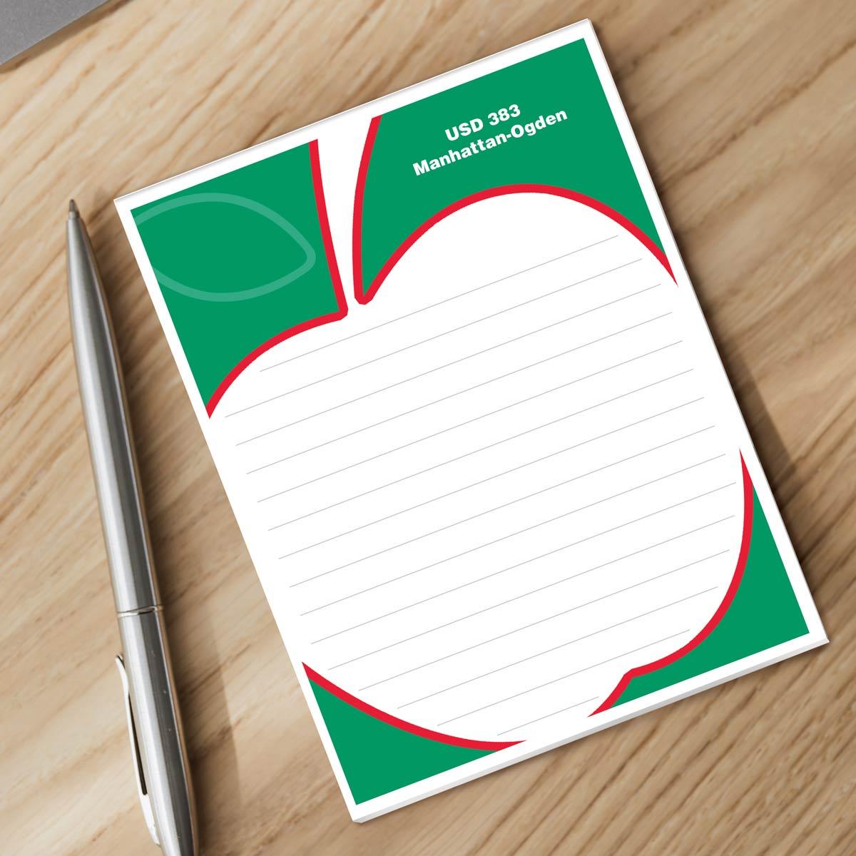 personalized apple notepad and silver pen sitting on a desk