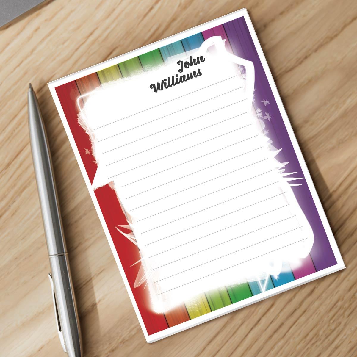 personalized notepad and silver pen sitting on a desk