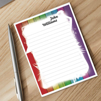 personalized notepad and silver pen sitting on a desk