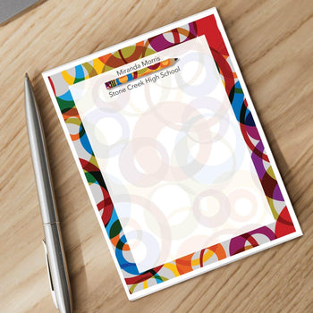 personalized notepad and silver pen sitting on a desk