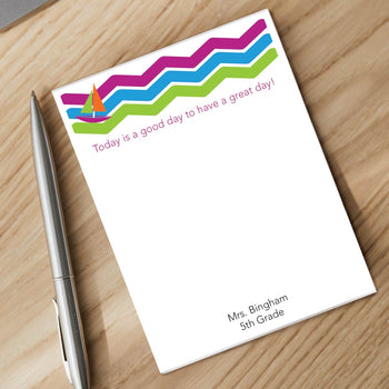 personalized sailboat notepad and silver pen sitting on desk