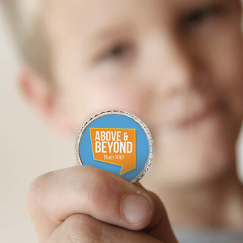 a boy holding an above and beyond coin