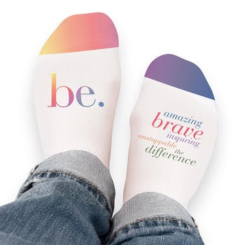 Pair of no-show socks with a colorful Be The Difference message on top.