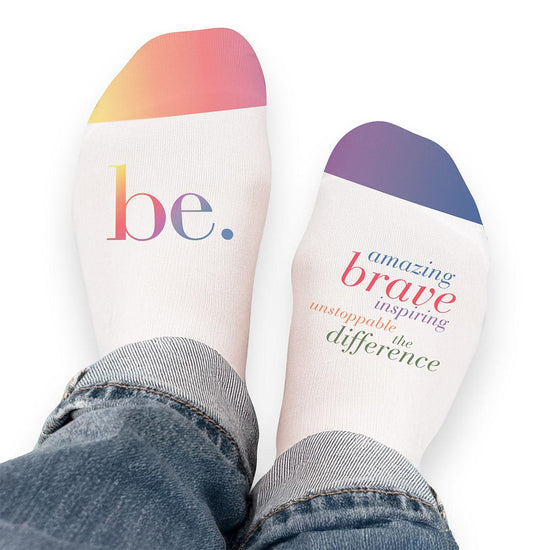 Pair of no-show socks with a colorful Be The Difference message on top.