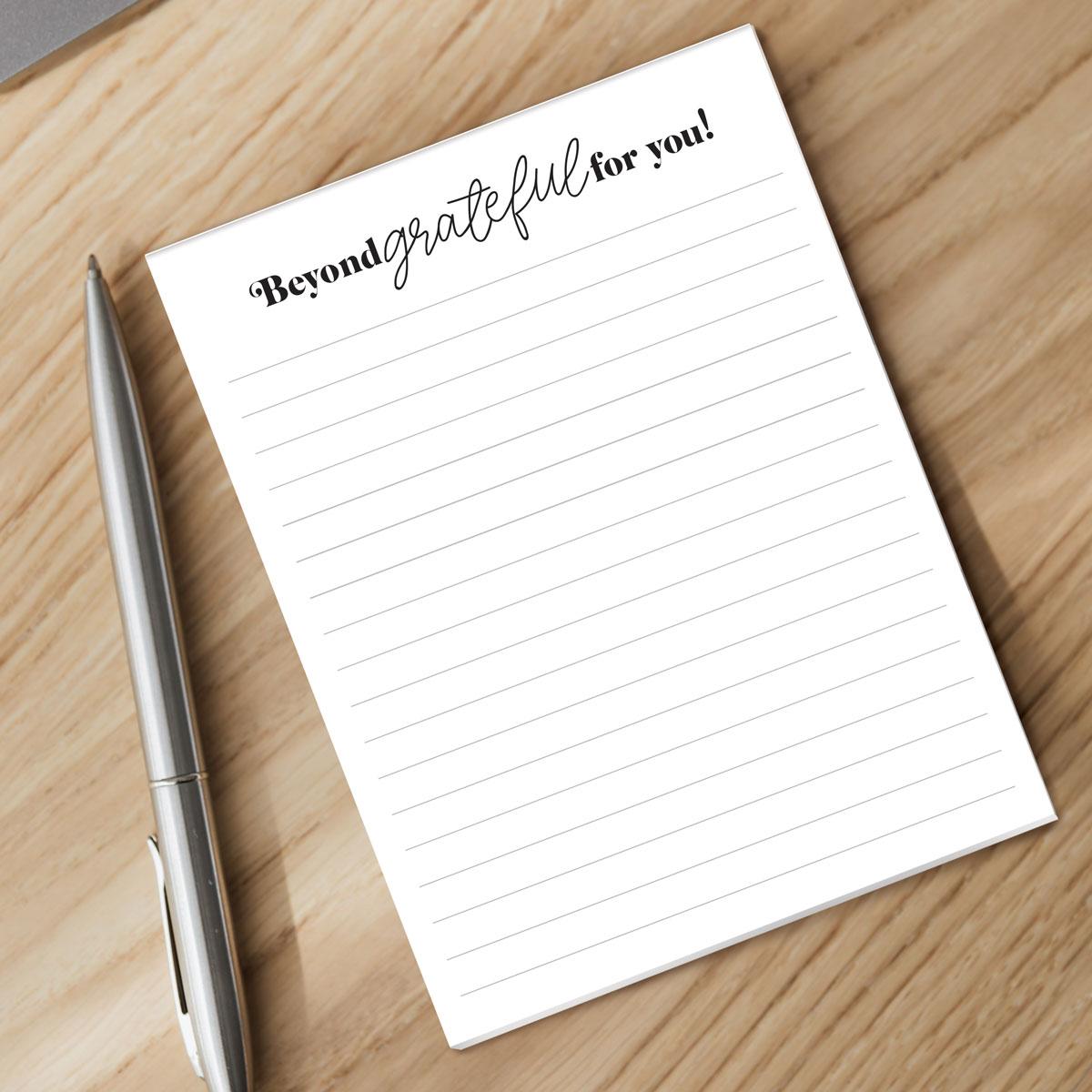 beyond grateful notepad and pen sitting on a desk