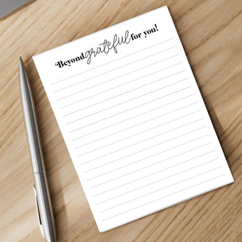 beyond grateful notepad and pen sitting on a desk
