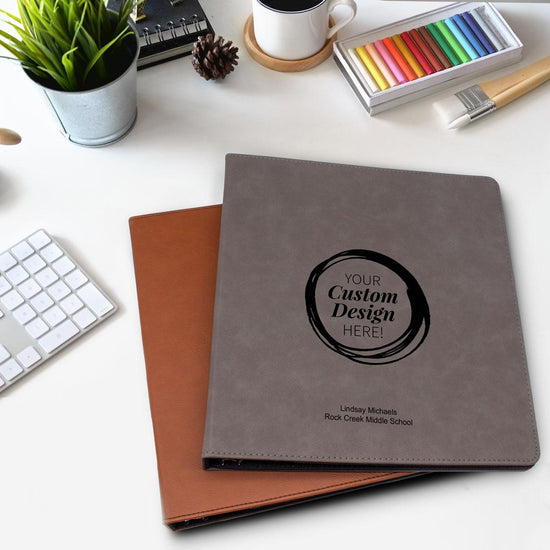 create your own rawhide and gray leather notebooks sitting on a desk
