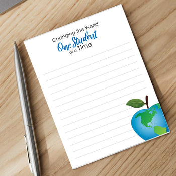 one student at a time notepad with a pen sitting on a desk