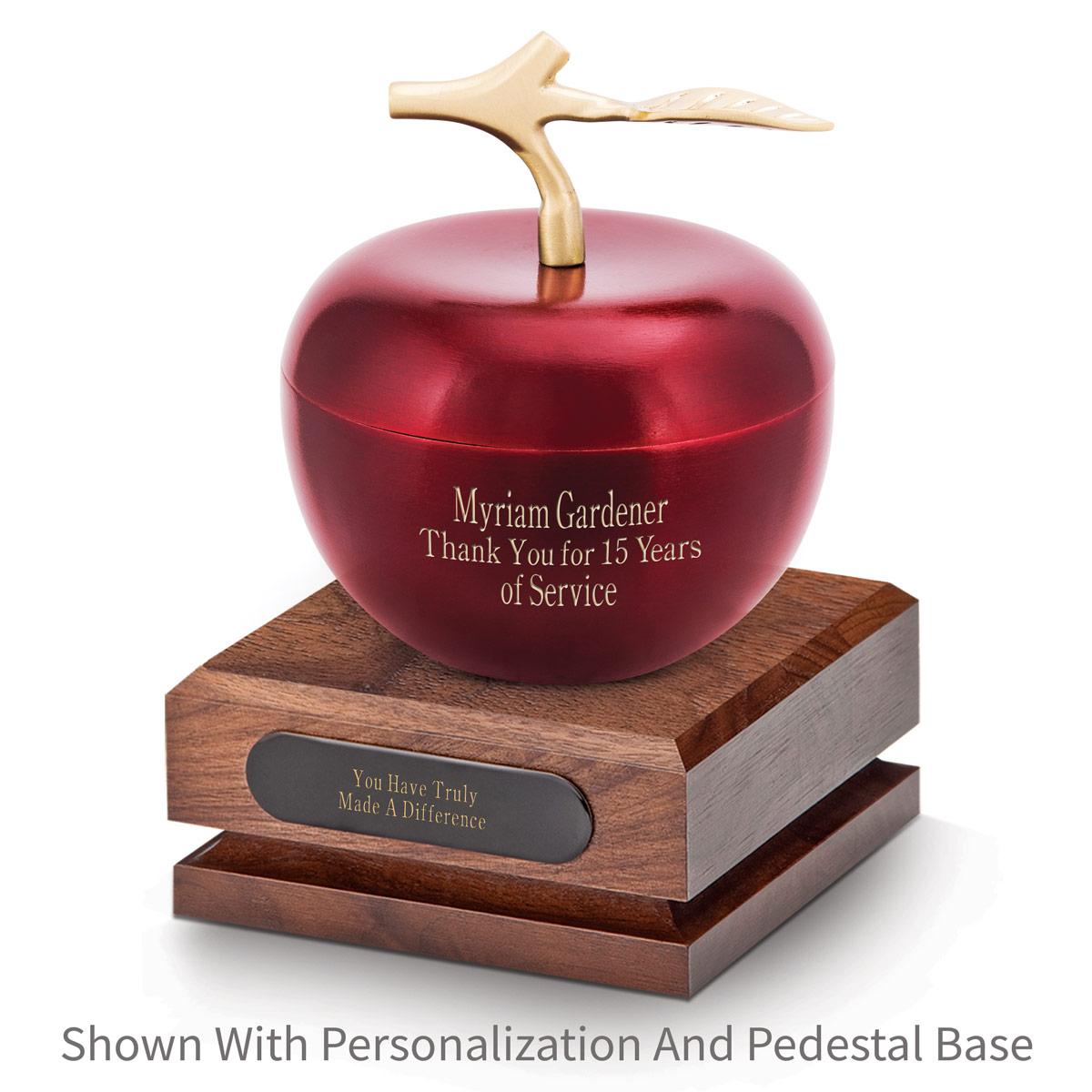 crimson apple dish sitting on top a walnut base with black brass plate
