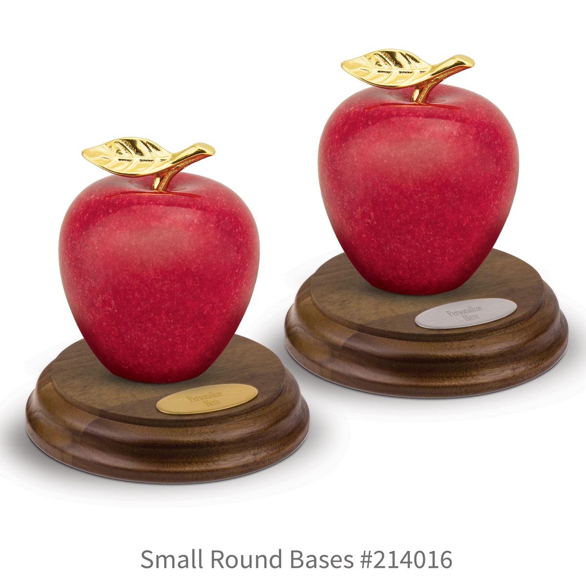 round walnut bases with brass and silver plates and marble apples