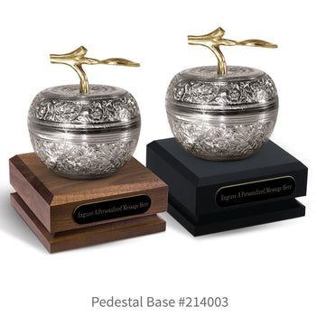 black and a brown walnut pedestal bases with black brass plates and silver embossed apple dishes