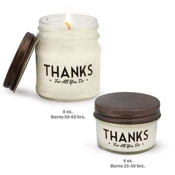 two white candles in glass jars with thanks message