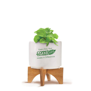 Bamboo Stand With White Ceramic Pot. Inspirational Saying: Every Day, Your Commit-Mint & Encourage-Mint Makes A Difference.