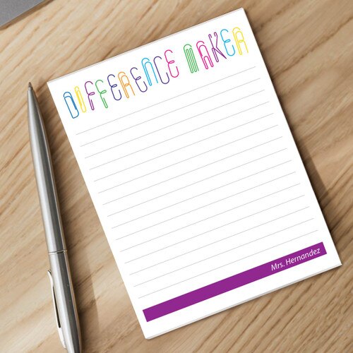 difference maker notepad and silver pen sitting on a desk